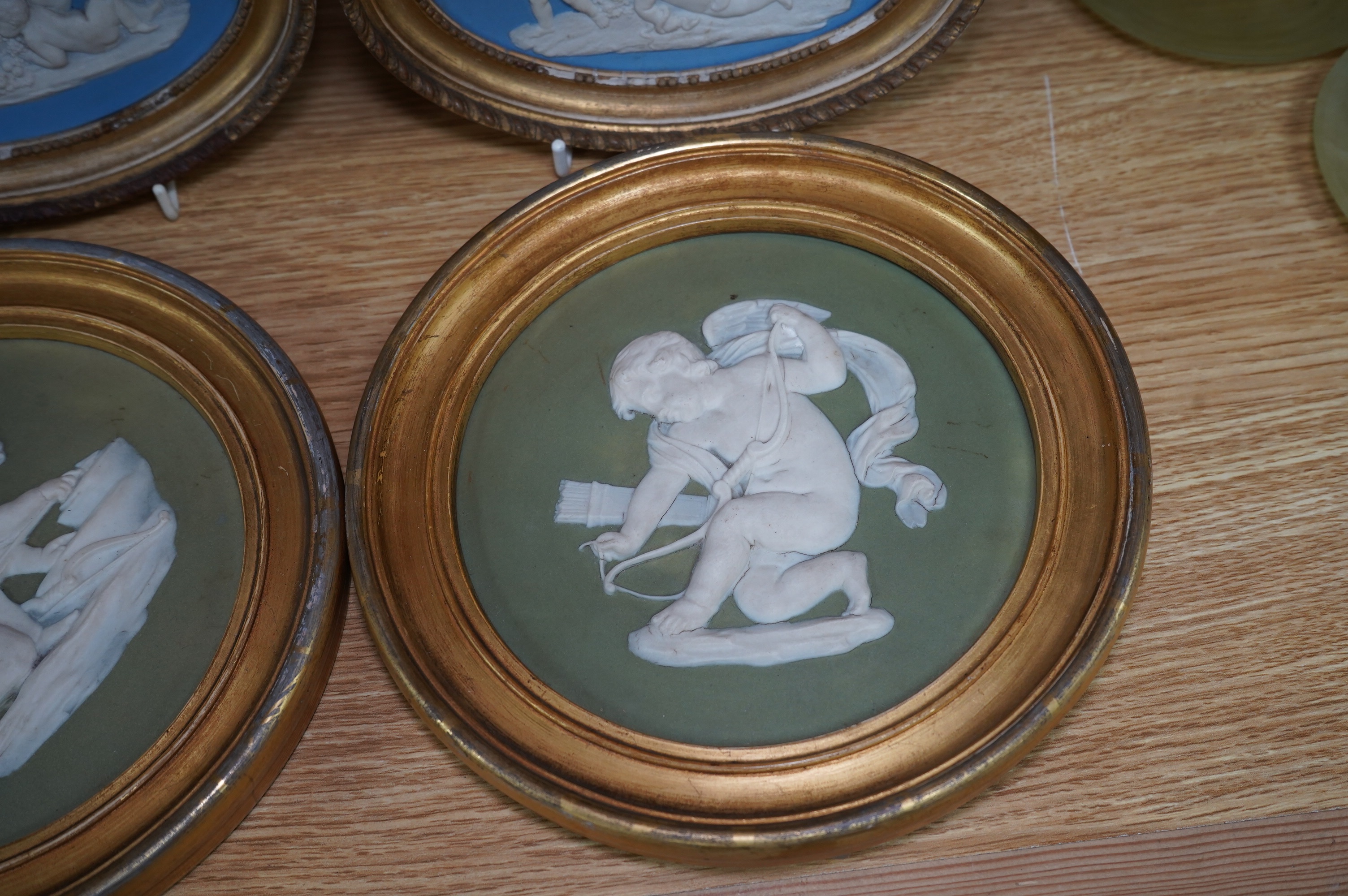Two pairs of jasperware plaques, probably Wedgwood, in gilt frames, largest 19cm in diameter. Condition - fair to good